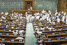 Opposition members protest in the well of the Lok Sabha during the Monsoon session of Parliament in New Delhi on Wednesday. (Sansad TV via PTI Photo)