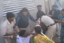 Image shows a man hitting a police man with a rock in Telangana's Adilabad.