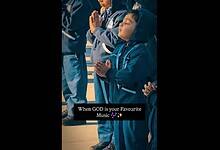 School boy dances during prayer