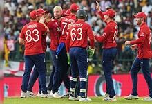 England cricket players celebrating after a wicket in T20 World Cup match.