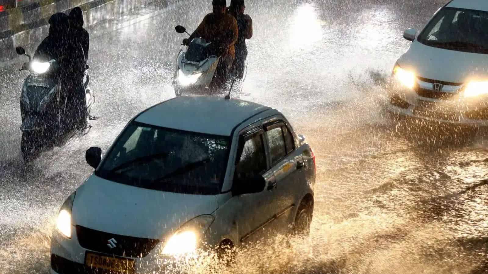 Flooded Hyderabad streets during unseasonal rains with cars and motorbikes in water.