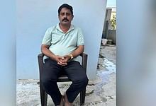 Man sitting outdoors in casual attire at The Siasat Daily office.