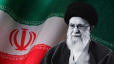Ayatollah Khamenei, Iran's Supreme Leader, pictured with national flag during a public appearance.
