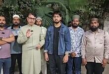 Community leaders and activists gathered outdoors for a discussion.