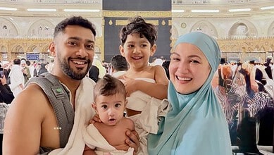 Gauahar Khan and her two sons at the holy Kaaba during Umrah, capturing a joyful moment of family devotio.