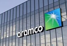 Modern Aramco office building with glass facade and company logo in Saudi Arabia.