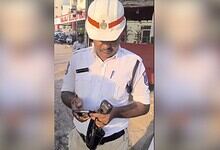 Traffic police officer in uniform using a mobile phone during duty.