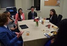 A Hyderabadi man speaking to a diverse group during Ramzan in Virginia, highlighting cultural unity and c.
