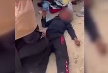 Deported Jewish-American man lying on the ground after witnessing a Palestinian child hit by a car in Wes.