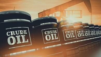 Oil storage tanks with "Crude Oil" labels against sunset sky, symbolising stable oil supplies amid Gulf t.