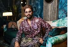 Allu Arjun attending a media event, dressed in a patterned outfit with sunglasses.