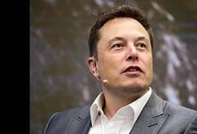 Elon Musk speaking at a SpaceX event, focusing on space exploration and innovation.