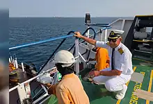 Iraqi captain supervises crew on oil tanker deck in Gulf of Oman.