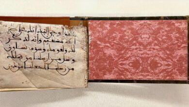 Rare handwritten Quran manuscript with aged pages and Arabic calligraphy, displayed in Makkah.