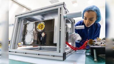Engineer works on Shams satellite assembly in Saudi laboratory.