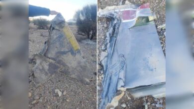 Wreckage of a downed aircraft with visible metal fragments and markings, reportedly from a US jet in Iran.