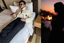 Veer Pahariya relaxing on a hotel bed, mystery girl silhouette at sunset in the background.