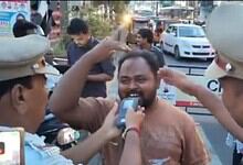 A man happily interacts with police officers during a street celebration, capturing a joyful moment amids.