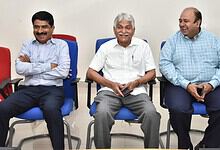 Experienced professionals engaging in a lively discussion during a corporate meeting at The Siasat Daily.