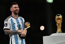 Argentina football team celebrating with trophy, Messi holding Ballon d'Or, during FIFA World Cup 2026.