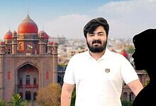 A man standing in front of the Red Fort in Delhi, India, during daytime.