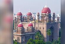 A grand historic fort with red domes and lush greenery in the foreground, showcasing traditional Indian a.