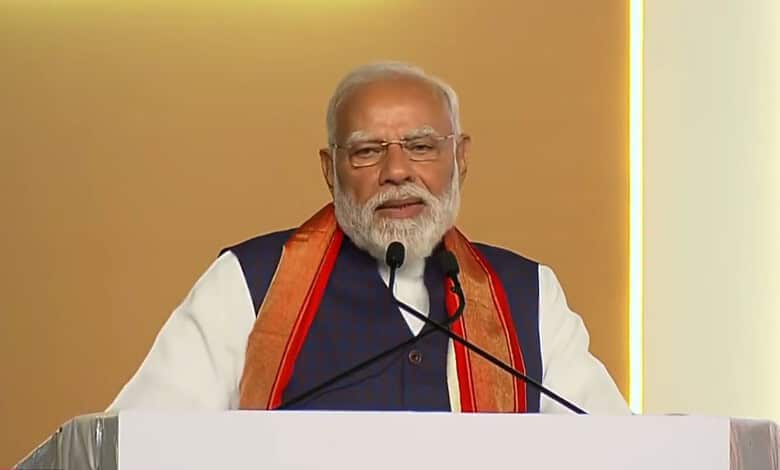 Prime Minister Narendra Modi speaking at a public event in Hyderabad, addressing the crowd during his vis.