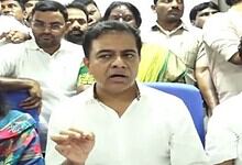 A man speaking to a group of people during a press conference or meeting.