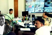 Police officers and officials in a meeting room with multiple screens displaying traffic footage.