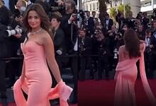 Gangu at Cannes wearing a pink gown, surrounded by photographers and media at the red carpet event.