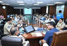Business leaders and officials attending a formal meeting in a modern conference room.