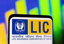 LIC logo displayed on a digital screen with colourful financial graphs in the background.