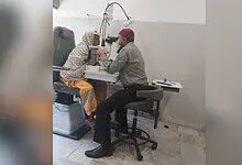 Eye examination at Abid Ali Khan Eye Hospital with doctor and patient using slit lamp.