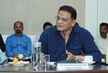 Honourable Minister Md. Azamuddin speaking at a formal meeting with colleagues.