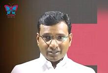 Hyderabad-based journalist KV Reddy in a white shirt and glasses during a public appearance.