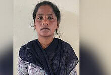 Empowered woman in traditional attire looking directly at the camera, symbolising strength and resilience.