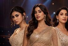 Elegant women in glamorous sarees at a formal event, showcasing traditional attire and jewelry, with a so.