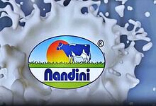 Nandini Dairy Milk logo splashing into milk, symbolising freshness and quality.