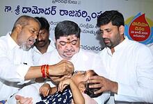 Officials administering polio drops to a child during a vaccination campaign in Telangana.