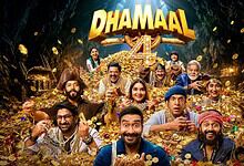 Cast of Dhamaal 4 celebrating amidst gold coins and treasure in a cave setting.