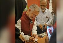 Mughal period example of religious pluralism: Michael Calabria signing a document with diverse scholars.