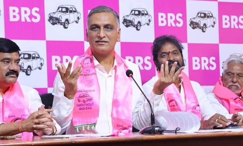 Telangana politician Harish Rao speaking at a press conference with BRS banners in the background.