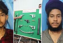 Two young men with illegal arms seized by Bidar police, displayed on a green board.