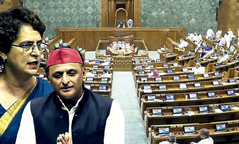 Priyanka Gandhi in Parliament, discussing with a man wearing a red cap.