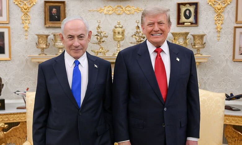 Donald Trump and Benjamin Netanyahu smiling during a meeting in a decorated room.