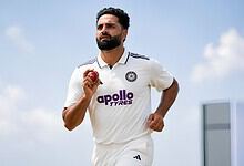J-K fast bowler Auqib Nabi holding a cricket ball on the field.