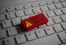 Red warning key with 'Data Breach' on a computer keyboard.