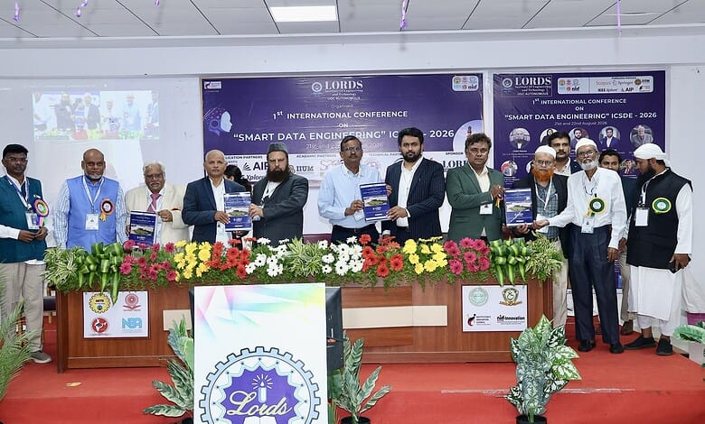Group of professionals at Hyderabad LIET conference on smart data engineering, holding certificates.