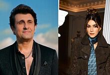 Sonu Nigam and Kriti Sanon posing indoors, stylish outfits, elegant setting.