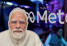 Indian Prime Minister Narendra Modi at a public event with a blurred background.